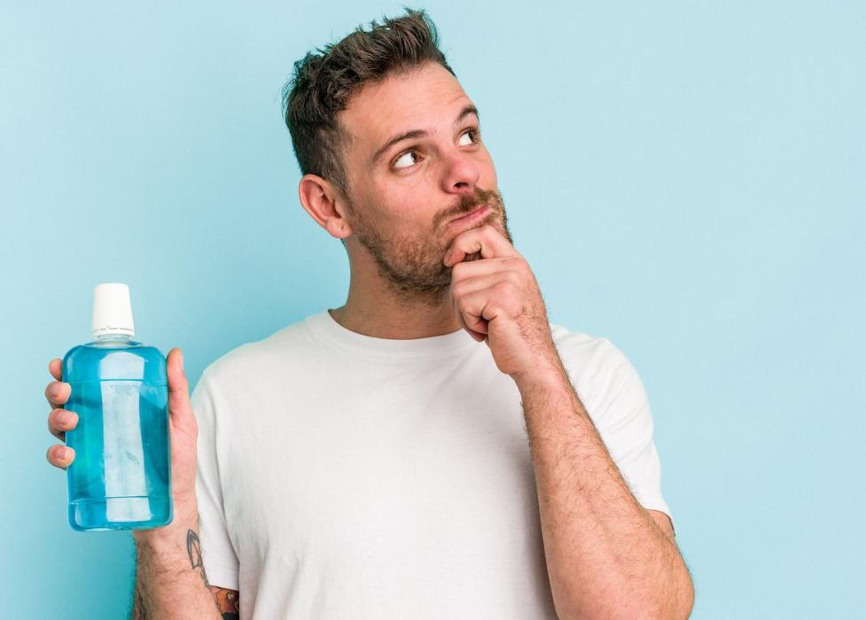 man holding a mouthwash