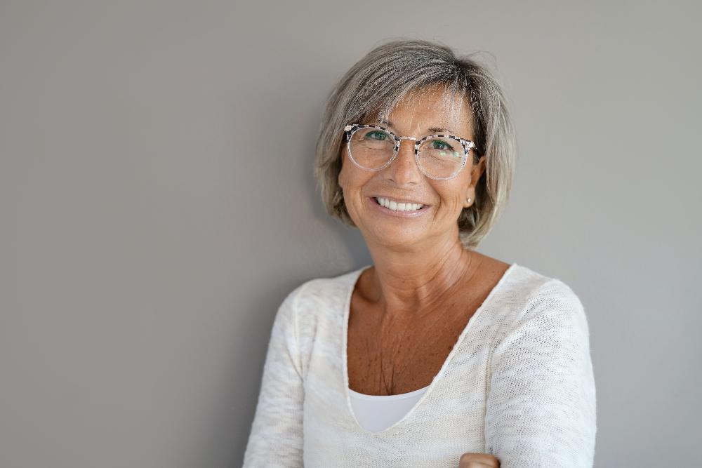 woman with glasses smiling l dentures mesquite tx