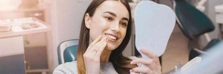 Woman smiling after dental work in 75150