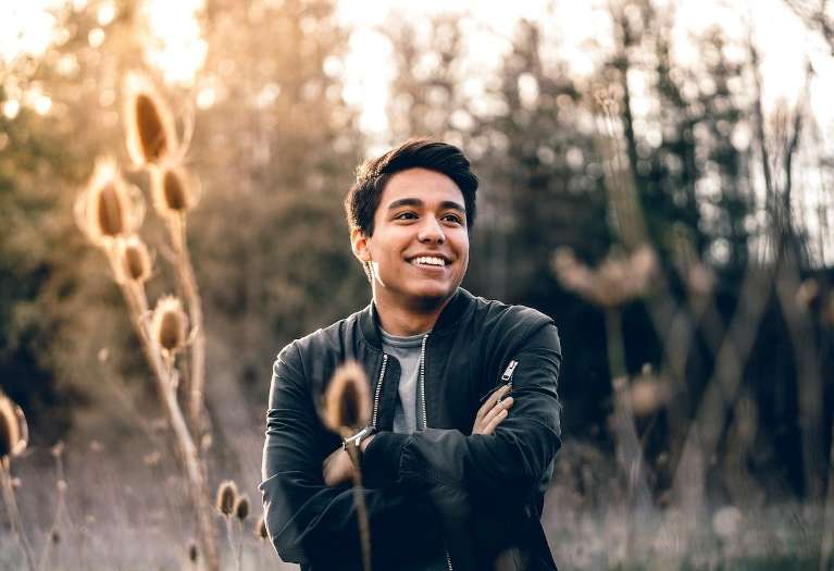 Smiling young man considering cosmetic dental options in Mesquite TX