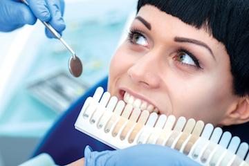 woman picking out tooth whitening shade l dentist 75150